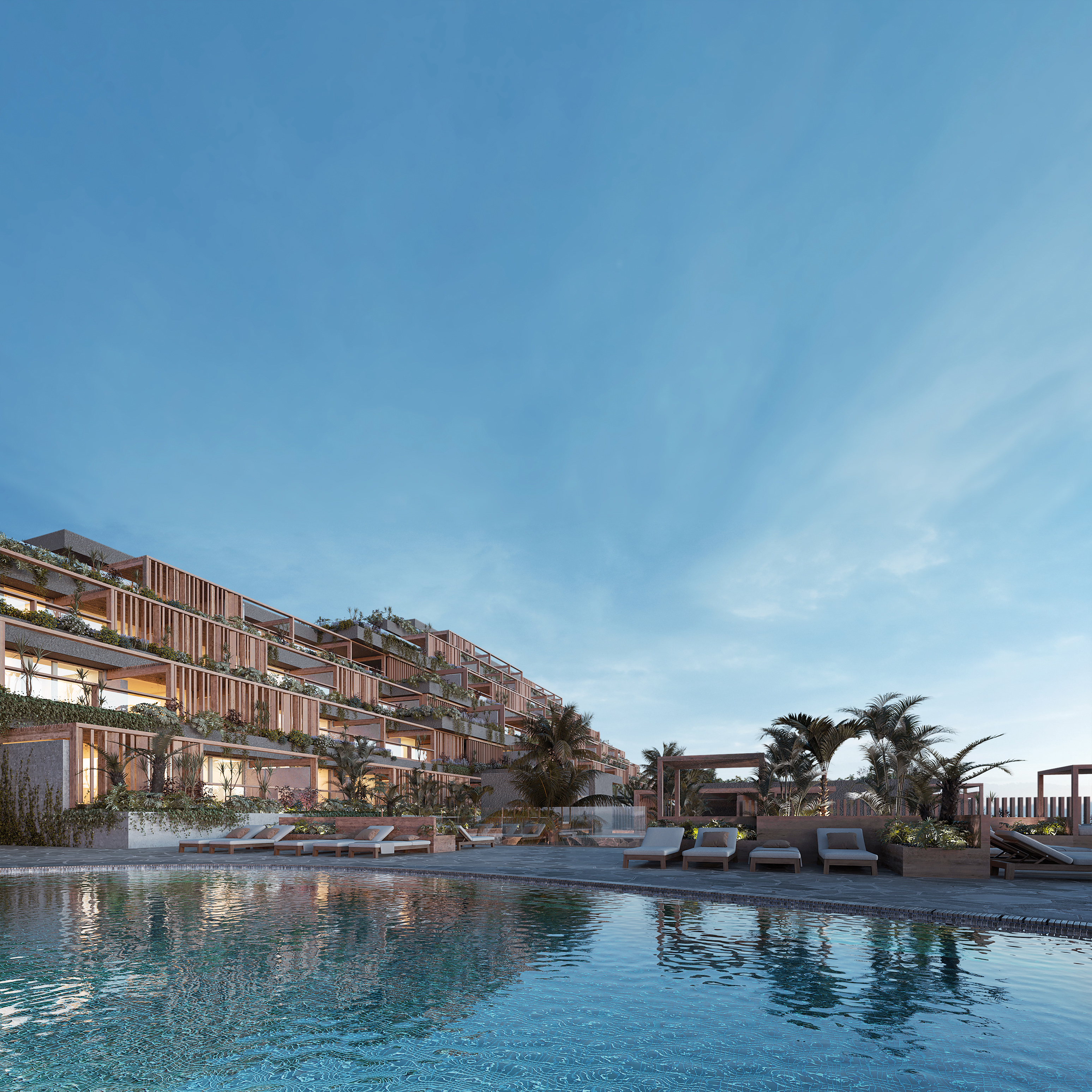 Vista del complejo residencial Tamaragua Residences con piscina al atardecer